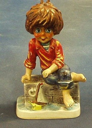 A Goebal figure of a seated boy with model yacht, the base marked Mic10 9"