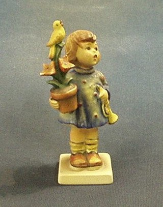 A Goebal figure of a standing girl with plant pot and canary, the base marked 1971 6"