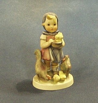 A Goebal figure of a standing girl with chicken, the base marked 199/0 5"