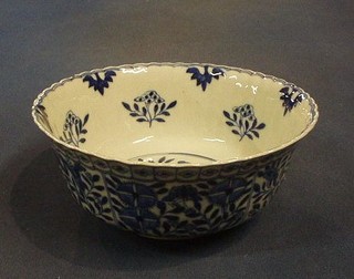 A 19th Century Oriental blue and white circular bowl, the interior painted flowers, the exterior with floral decoration, the base with 4 character mark 7" (slight chip to rim)