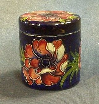 A modern cylindrical Moorcroft anemone pattern jar and cover, the base impressed Moorcroft England, 4"