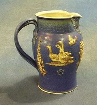 An attractive jug decorated chickens with strap work handle, the base marked Martin Homer 7"