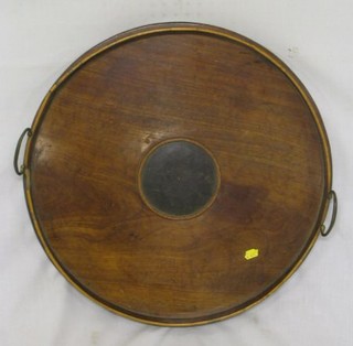 A 19th Century circular mahogany twin handled tea tray 20"