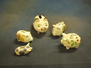 A collection of 13 piggy banks