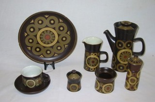 A  Denby 21 piece  Arabesque pattern coffee service with coffee pot, cream jug, pepper pot, mustard pot, circular storage pot 3" (no lid), 4 cups (1 cracked), 3 saucers, 4 - 10" dinner plates (1 cracked), 5 - 7" tea plates