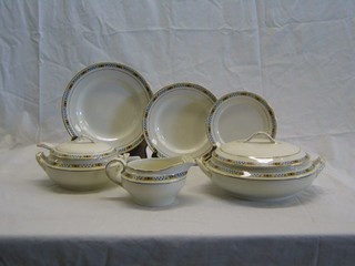 A 43 piece Art Deco pottery dinner service comprising 2 twin handled tureens and covers, sauce tureen and ladle, 2 oval meat plates, sauce boat, 12 dinner plates, 12 side plates, 12 tea plates, circular plate