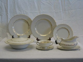 A 28 piece Royal Doulton Fairfax pattern dinner service comprising oval meat plate, 2 lidded vegetable tureens (1 chipped), 6 11" dinner plates, 6 8" side plates, 6 twin handled soup bowls and saucers (1 bowl cracked), sauce boat and stand