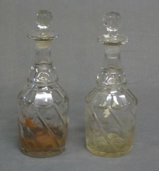 A pair of panel cut glass mallet shaped decanters