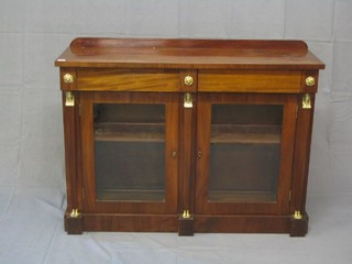 An Empire style mahogany chiffonier with raised back, fitted 2 drawers above a double cupboard enclosed by glazed panelled doors and with gilt metal sphinx mounts 48"
