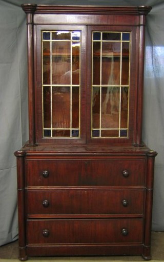 A 19th Century "Scots" secretaire bookcase, the upper section with moulded cornice, the interior fitted adjustable shelves enclosed by lead glazed panelled doors, the base with well fitted secretaire drawer above 2 long drawers, having columns to the sides 45"