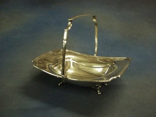 A rectangular silver plated cake basket with swing handle