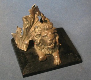 A 19th Century cast "silver" head of a seated lion within laurel leaves, formerly part of a table centre piece 4"