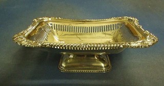A pierced rectangular silver plated fruit basket with gadrooned borders