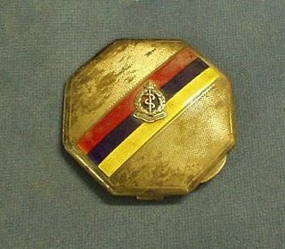 A silver and enamel octagonal shaped powder compact in the colours and cap badge of the Royal Army Medical Corps, Birmingham 1940 by the Goldsmiths and Silversmiths Co. 3"