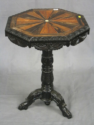 A 19th Century Anglo-Indian octagonal specimen table, the lid inset numerous exotic woods, raised on a carved column tripod support 21"