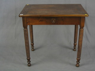 A 19th Century Continental walnutwood side table fitted a drawer, raised on ring turned supports 32"