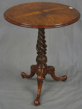 A Victorian circular figured walnutwood wine table, raised on a spiral turned and tripod supports, 23"