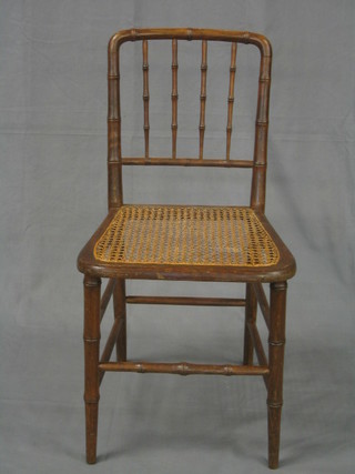 A set of 4 bamboo stick and rail back dining chairs with woven cane seats