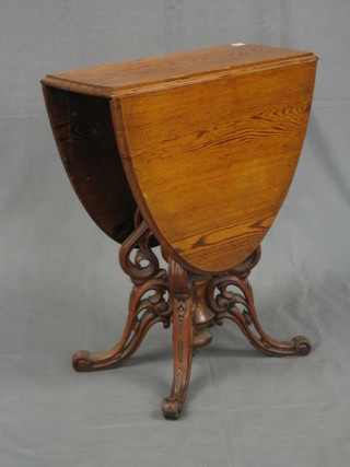 A 19th Century Continental pine oval drop flap pedestal occasional table, raised on a pierced turned column 24"