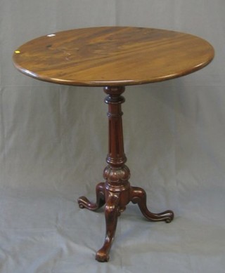 A 19th Century circular walnutwood snap top tea table, raised on a later turned and fluted base 32"