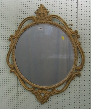 A circular plate wall mirror contained in a decorative frame 24" 20-30