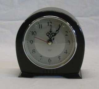 A Smiths battery operated electric clock with silvered chapter ring and Roman numerals contained in an arched brown Bakelite case