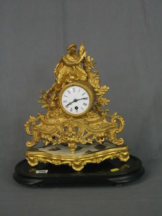 A Victorian French 8 day mantel clock wth drum movement, the painted dial with Roman numerals, contained in a gilt spelter case surmounted by a figure of a standing gentleman