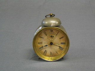 A 19th Century circular metal alarm clock, the paper dial marked patented March 27th 1877