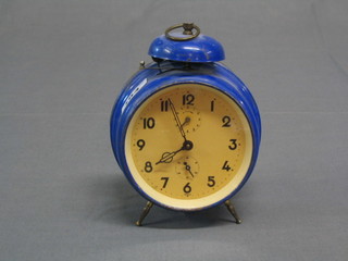 A 1938 Continental alarm clock contained in a blue metal case