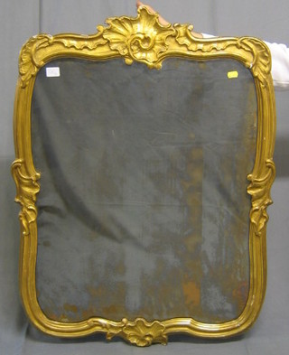 A 19th Century shaped plate mirror contained in a decorative gilt carved frame 36"