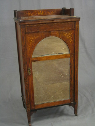 A Victorian inlaid rosewood music cabinet with three-quarter gallery, the interior fitted shelves enclosed by an arched bevelled plate mirror panelled door, 22"