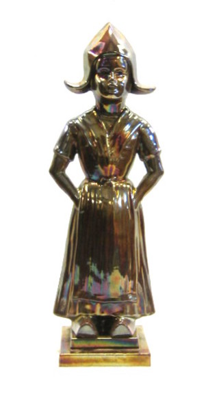 An anodised fireside companion set in the form of a standing Dutch girl