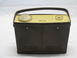 A portable radio contained in a leather case