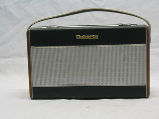 A Roberts portable radio contained in a teak and black fibre case