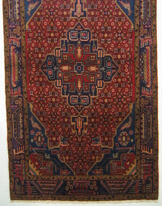 A contemporary Hamadan rug with central medallion within multi-row borders 103" x 57"