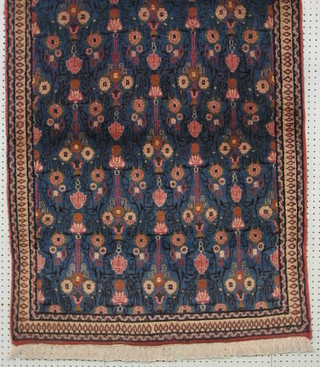A contemporary Persian Veramin rug, blue ground and floral patterned 57" x 36"