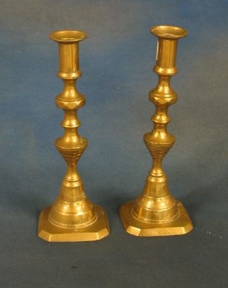 A pair of 19th Century brass candlesticks with knopped stems 9"