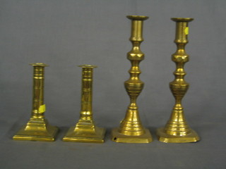 A pair of 19th Century brass candlesticks with knopped stems 10" and a smaller pair on square bases 6"