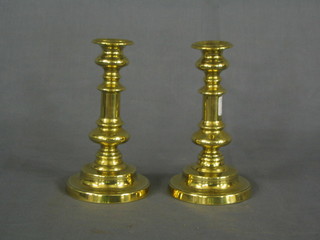A pair of circular brass candlesticks with ejectors 7"