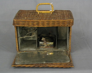 A 1920's rectangular wicker Primus stove  box with hinged lid, the interior fitted a metal divider with 3 sections 13"