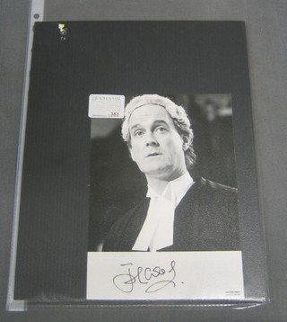 A black and white signed photograph of John Cleese in barristers wig and gown
