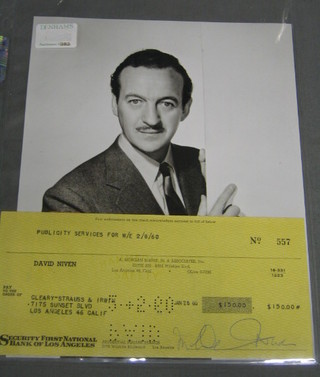 A cheque signed by David Niven dated 2/8/60, for $150.00 payable to Cleary-Strauss & Irwin and a black and white photograph