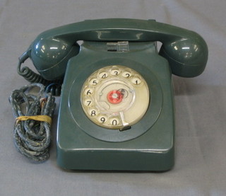 An old blue plastic dial telephone 