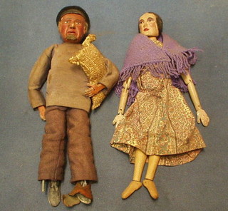 A carved wooden doll, 1 other "Fisherman", a 1960 Sindy Doll and a North Sea oil medallion 