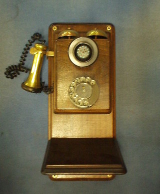 A reproduction wall mounting candlestick telephone