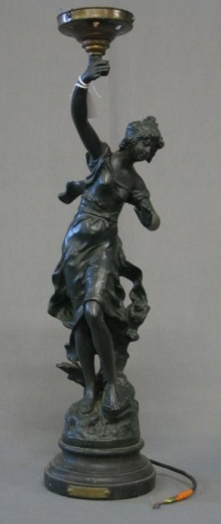 A 19th Century spelter lamp in the form of a standing lady with torch 22" (f)
