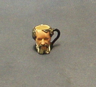 A Royal Doulton tiny character jug "Charles Dickens" D6676 (slight chip to rim)
