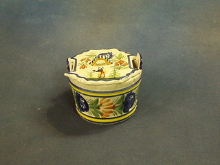 A circular Quimper butter dish and cover, the lid decorated a standing lady, the base marked HB Quimper 298 2, 4"