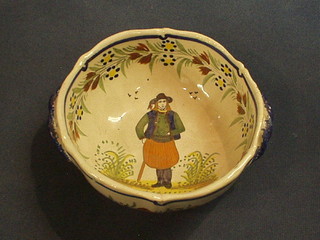 A circular twin handle Quimper dish decorated a figure of a gentleman, the base marked Henriot Quimper France 5"