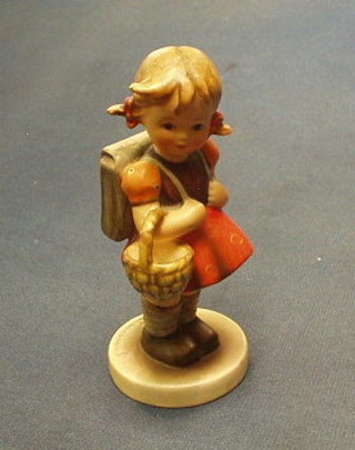 A Hummel figure of a standing girl with hat and umbrella, the base marked 1870 5"